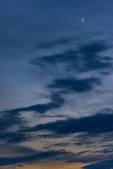 Naklejka na ściany i meble Moon against the setting sky and clouds