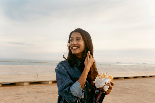 indian woman eating a sandwich