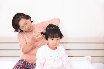 Grandma braids granddaughter