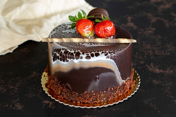 Chocolate birthday cake on dark background