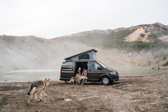 Young couple in a camper van in nature during winter