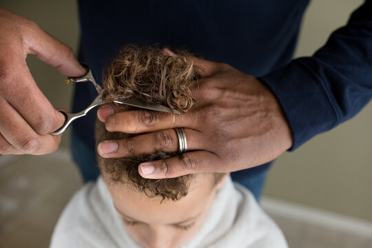 Man with wedding ring cuts son's hair