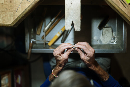 Old jeweler working on a workshop