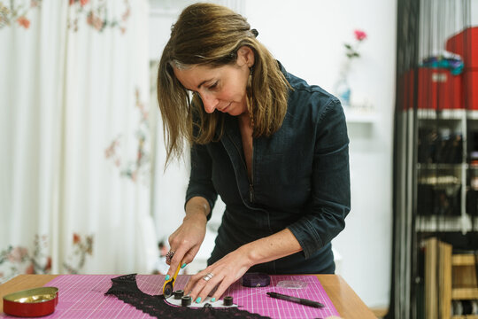 Woman cutting lace fabric