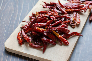 Dried red chili on wood plate.