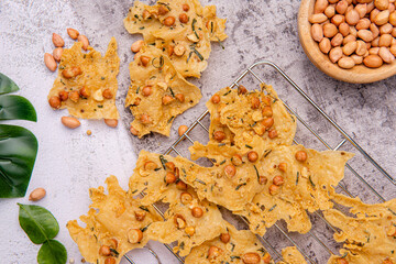 Rempeyek or peyek kacang is a deep-fried savoury Indonesian-Javanese cracker made from flour (usually rice flour) with peanut, lime leaves and other ingredients, bound or coated by crispy flour batter