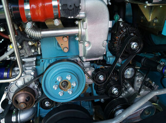 Close up view on new bus electric engine compartment, motor belts, pulleys, gears, alternator and...