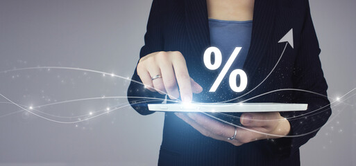 Business. Finance. Wealth. White tablet in businesswoman hand with didgital hologram Interest rate...