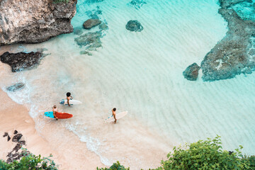 a group of guys with boards goes surfing