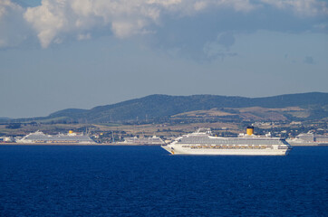 Costa cruiseships or cruise ship liners Pacifica, Fortuna and Favolosa anchored at sea offshore of Civitavecchia, Rome in Italy on sunny summer day with blue sky due to Corona Pandemic Pause