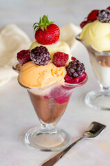 Ice cream in glass bowl. Ice creams on a white background. Milk, chocolate, cherry, melon and caramel ice cream.