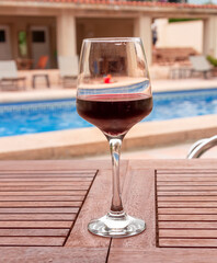 A GLASS OF WINE ON A TABLE
