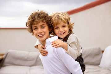 Positive boys playing together on terrace
