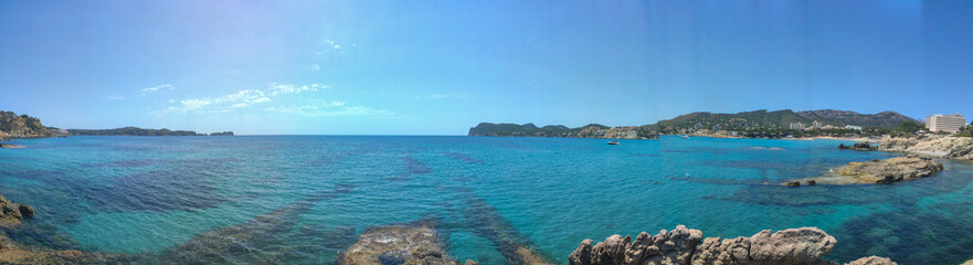 Fototapeta premium Panorama seacoast of the beach in mallorca with beaturiful view of the sea. Sea view of turquoise colour. Concept of summer, travel, relax and enjoy