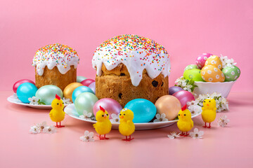 Easter cakes, eggs, chickens. Festive composition on pink background