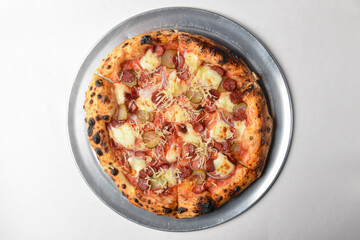 Pizza with bavarian sausages, Mozzarella cheese, onion and cucumbers isolated on white background.