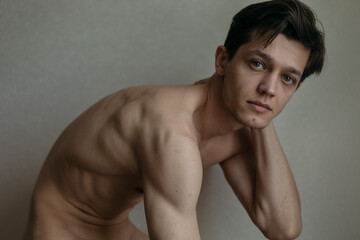 handsome man without clothes to the waist posing for the camera
