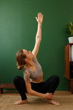 Woman ding twisted squat yoga pose