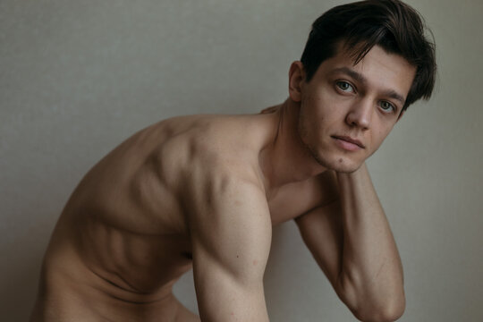 handsome man without clothes to the waist posing for the camera
