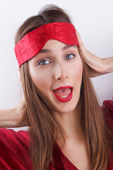 Young woman with red lips, with mask for sleep, young lady is surprised