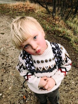 A blond toddler in the mountains 