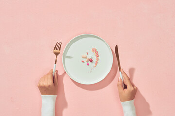 Supplementary food on the dish with fork and spoon on white table