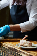 chicken thigh on a white plate on the background of the kitchen