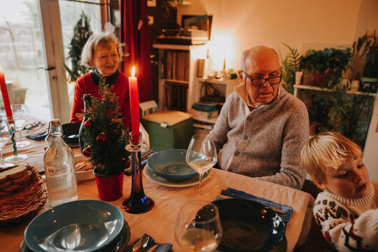 A kid and Grandparents on a Christmas table