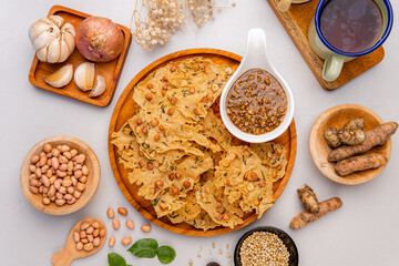 Rempeyek or peyek kacang is a deep-fried savoury Indonesian-Javanese cracker made from flour (usually rice flour) with peanut, lime leaves and other ingredients, bound or coated by crispy flour batter