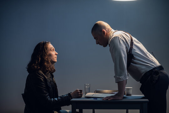 A police officer introduces the suspect to the details of the case