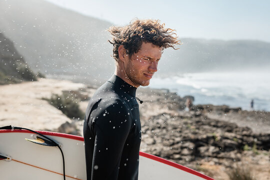 Gorgeous surfer shaking head