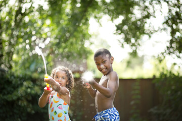 Excited kids spray viewer with water gun
