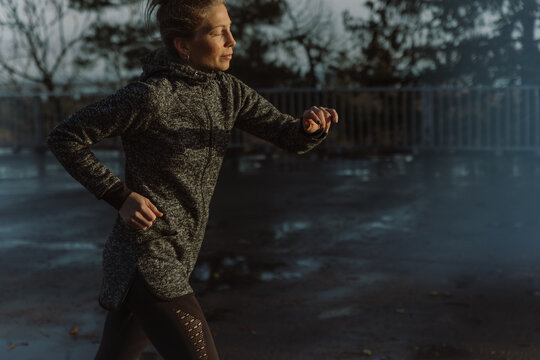 Woman running in spring rain