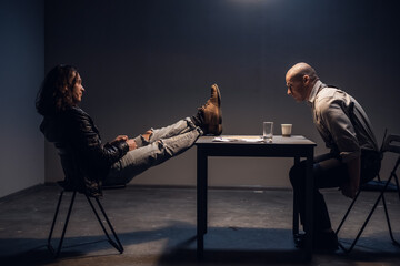 The suspect in the smuggling case is sitting relaxed and with his feet up on the table in the...