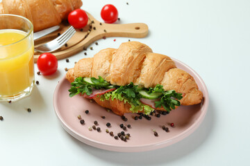 Concept of tasty eating with croissant sandwich, close up
