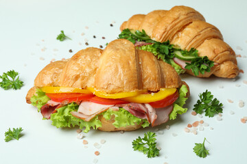 Concept of tasty eating with croissant sandwiches, close up