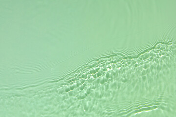 Green transparent clear water surface texture with ripples, splashes and bubbles Abstract summer...