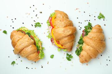 Concept of tasty eating with croissant sandwiches, top view