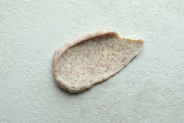 Skin care scrub on white textured background