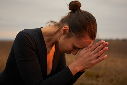 Woman doing yoga in the fields.