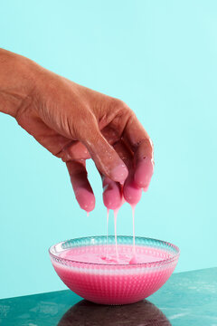 pink liquid soap on his hand