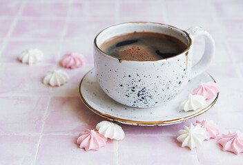 Cup with coffee and small meringues