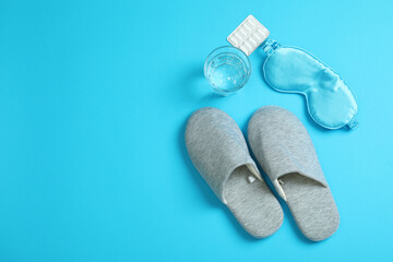 Sleep routine accessories on blue background, top view