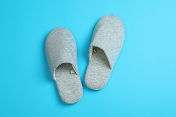 Pair of house slippers on blue background