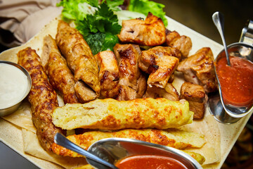 Baked kebabs and sausages. Close-up, selective focus