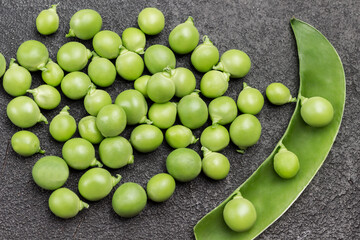 Peeled green peas on table. Opened pea pod