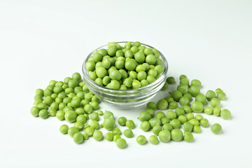Bowl with pea seeds on white background