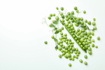 Fresh green pea seeds and pod on white background