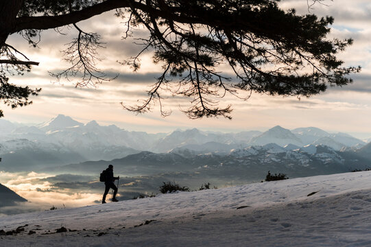 Side view of man hiking on snowy landscape 