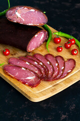 Turkish pastrami on a wooden serving plate. Pastrami is made from the ribeye and beef fillet parts of the cow.